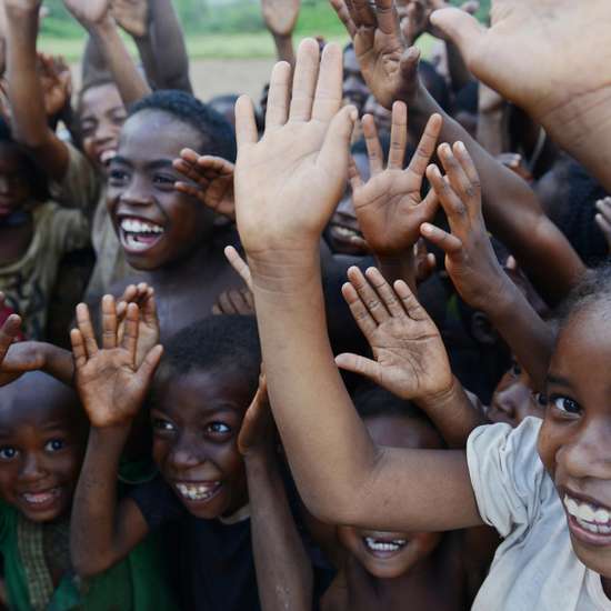 Joyful greeting of children in the project area Ravomena, Madagascar.