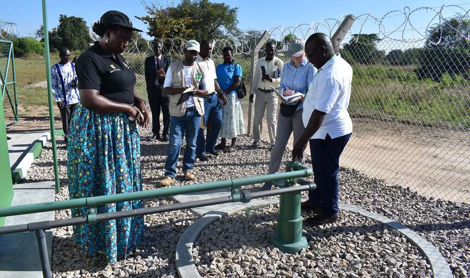 A group of people inspecting a water facility in Uganda