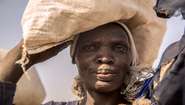 A woman at the refugee camp in Bentiu receives groceries.