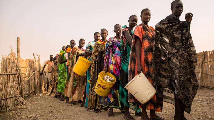 People queue up at a distribution of groceries at the refugee camp in Bentiu.