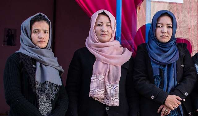 Graduates of Welthungerhilfe's vocational training programme in fron of their own business in Kabul