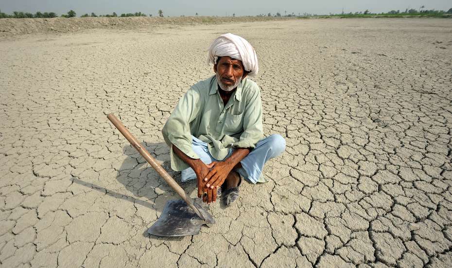 Anticipatory Action: A man is sitting on dry ground.