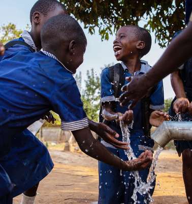 Children enjoy clean water at a well installed by Welthungerhilfe in Chitungwiza, Zimbabwe.