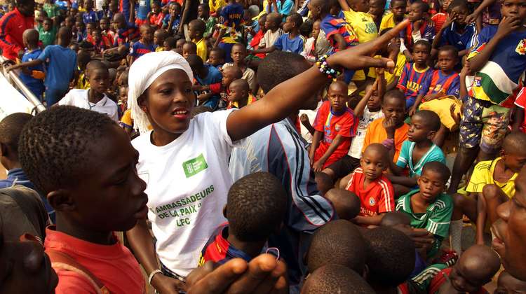 Yamale Dorcas, employee of "Frère Centrafricains", with applicants of the Football School for Peace in the stadium in Bangui.