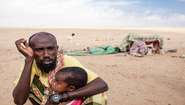 An exhausted father with his child during a drought in Somaliland