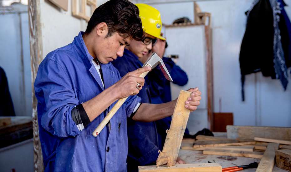 18-year-old Abdul working with wood