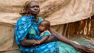 Nyaphini with her baby at the refugee camp Bentiu. She had to flee the violence in South Sudan with her family.