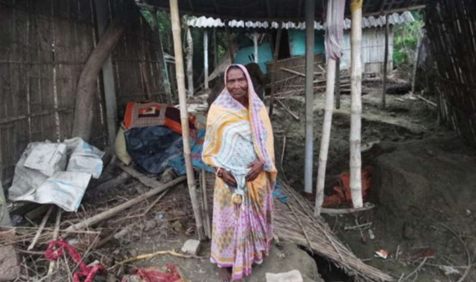 Fulia Devi in front of her destroyed home.