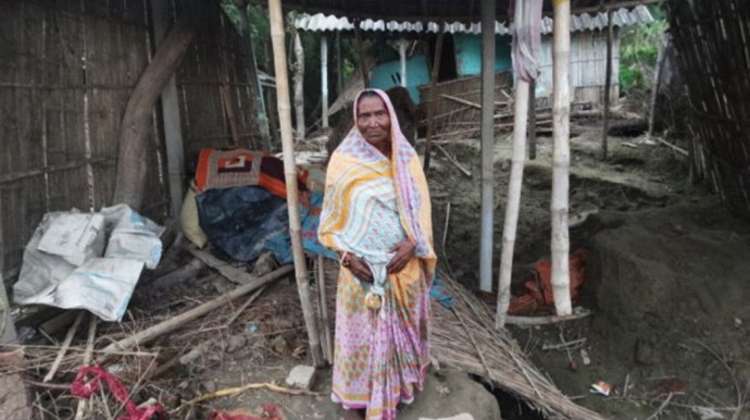 Fulia Devi in front of her destroyed home.