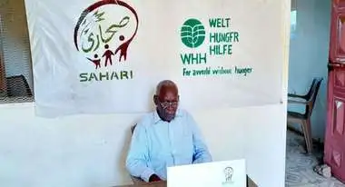 Humanitarian expert Mohamed Abdelkhani Abdalla in front of a laptop