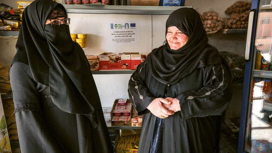 Salima and her sister Saliha stand in their newly opened shop in Al-Baghdadi, Anbar.