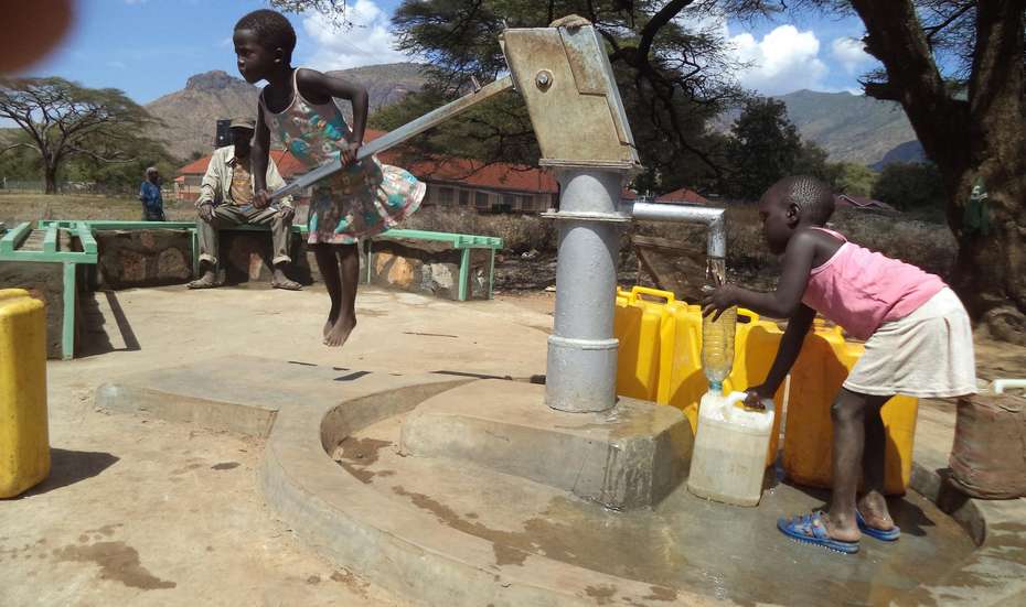 A brand-new drilled well in Moroto provides clean water. The new platform protects canisters from dirt, and the benches make the well a popular gathering place.