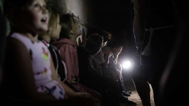 Ukrainian children sitting in a bunker