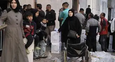People standing in line for relief aid distribution in Gaza.