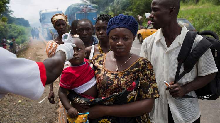 A woman and her child at an Ebola checkpoint