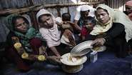 A group of Rohingya refugees in the Cox's Bazar district of Bangladesh have received food from the local population.