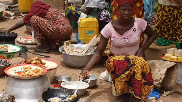 The former subsistence farmers are now selling surplus produce, including prepared goods, in the market.