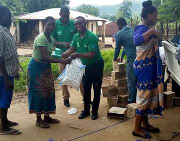 Welthungerhilfe staff members are handing out sacks of maize flour