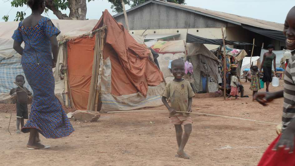 A child playing between tents at the airport in Bangui.