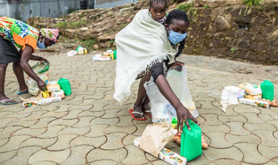 A mother carrying her child.