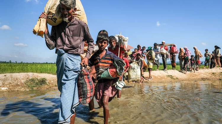 Rohingya refugees walking in a long line