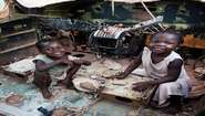 Two children are playing in a plane wreck at the IDP camp in Bangui