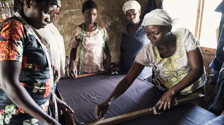Women sewing beekeeper suits