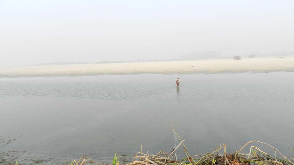 Boy crosses the river to go to school