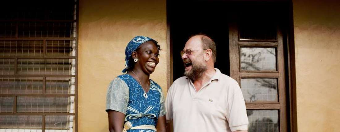 Press trip to Sierra Leone. Antoinette Saffa (Chief Accountant) and Franz Moestl (Project Manager) in front of their office. © World Hunger Aid